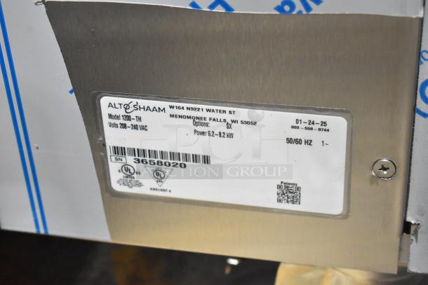 Brand new Alto Shaam 1200-TH commercial oven, stainless steel, model label showing 208-240 volts, 1 phase power.