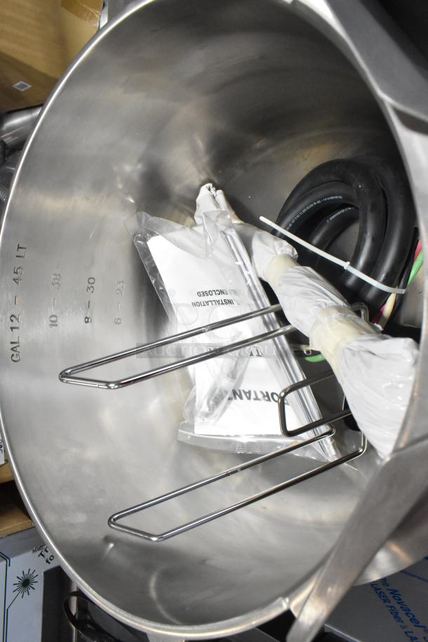 Brand new Vulcan MDMT-20 stainless steel 20-gallon tilting kettle, with measurement markings and installation manual.