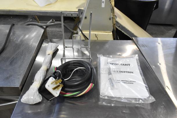 2024 Vulcan MDMT-20 stainless steel tilting kettle components, power cord, and manual, all brand new on metal surface.