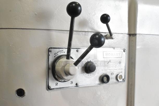Hobart M-802 metal commercial mixer control panel, featuring levers and dials. Plate shows make and model details.