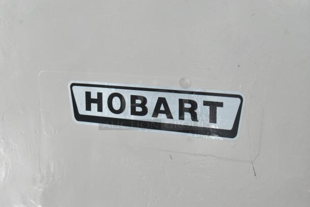 Hobart M-802 metal commercial dough mixer with attachments, 80-quart capacity, 208 volts, 3 phase, model label visible.