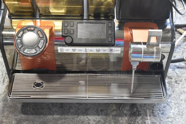 Thermoplan Mastrena II stainless steel commercial espresso machine with steam wand, touchscreen, and labeled controls.