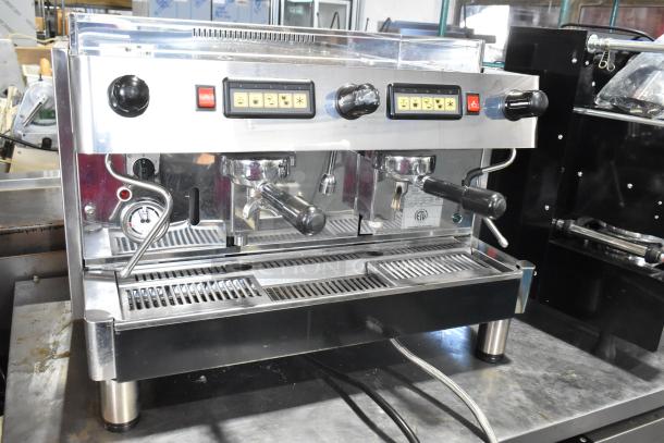 Grimac VD2GE stainless steel 2 group espresso machine, featuring 3 portafilters, 2 steam wands, and control panel.