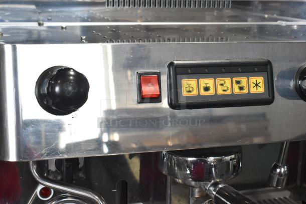 Grimac VD2GE stainless steel commercial espresso machine, 2 groups, 3 portafilters, 2 steam wands, control buttons visible.