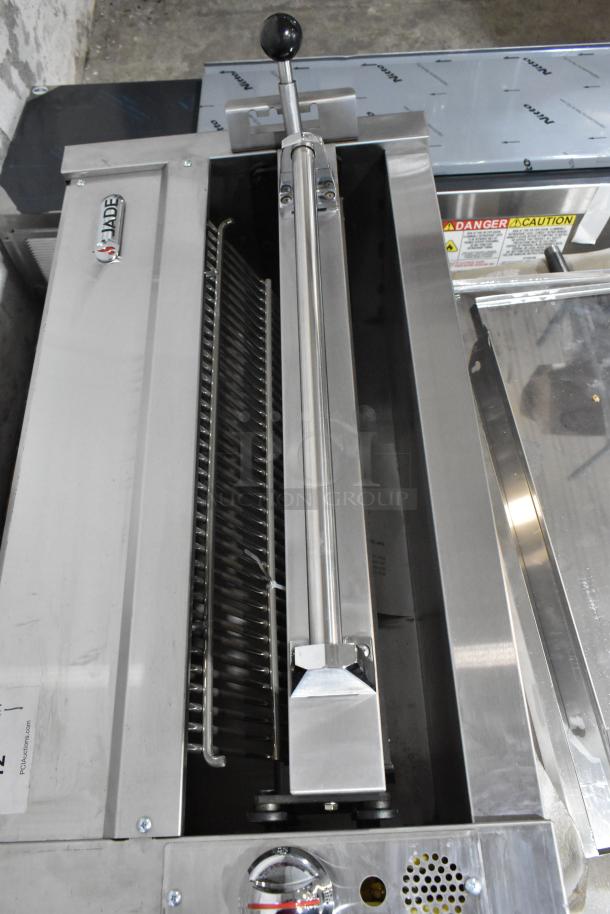 Brand new Jade Range gas-powered cheese melter attachment with backsplash, stainless steel, visible brand logo, safety labels.