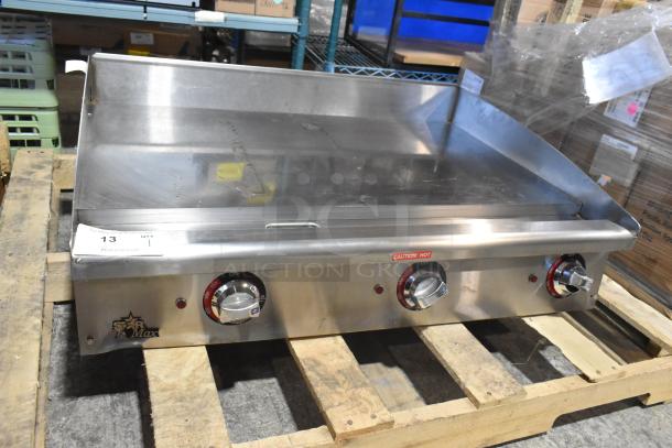 Brand new Star Max stainless steel commercial gas griddle, countertop model, with control knobs and "Caution Hot" label.