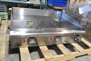 Brand new Star Max stainless steel commercial gas griddle, countertop model, with control knobs and "Caution Hot" label.