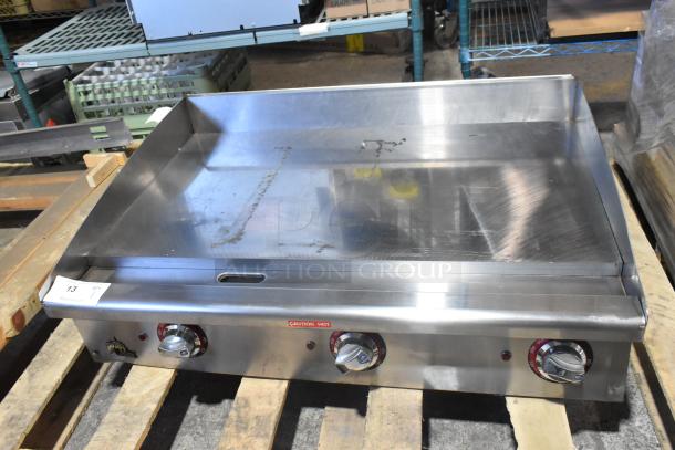 BRAND NEW Star Max stainless steel commercial countertop gas griddle, flat top, with control knobs and "Caution Hot" label.