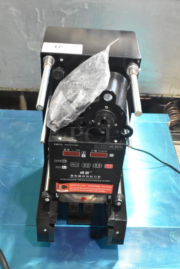 Metal countertop microcomputer automatic sealer, 115 volts, 1 phase, featuring control panel and metal rods, in used condition.