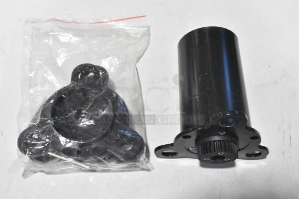 Black cylindrical component and additional parts in a sealed bag for a Metal Countertop Microcomputer Automatic Sealer. 115 Volts, 1 Phase.