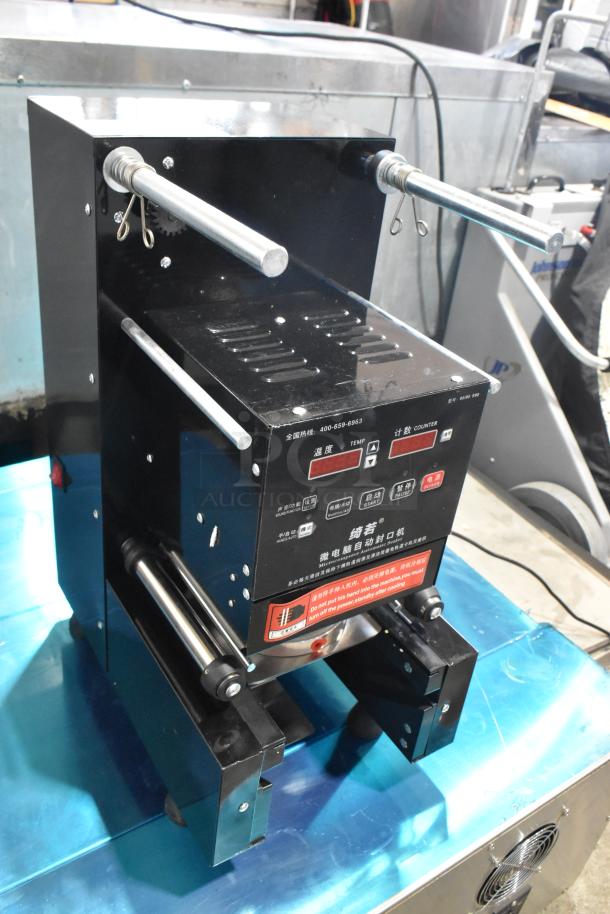 Metal countertop microcomputer automatic sealer, 115 volts, 1 phase, black with control panel and dual metal rods, pristine condition.