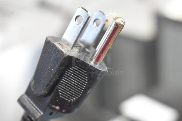 Close-up image of a power plug from a Metal Countertop Microcomputer Automatic Sealer, 115 Volts, 1 Phase.