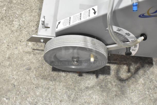 Johnson Wax Professional JWP-1572 metal floor waxing machine, featuring durable wheels and visible instructional labels.