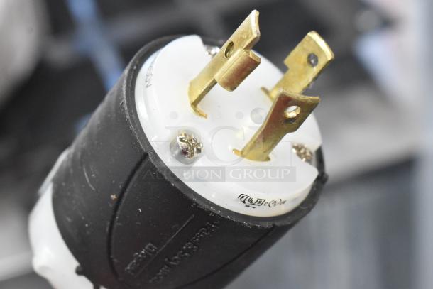 Close-up of a plug for Vevor HT-820 Stainless Steel Commercial Griddle, showing metal prongs and black casing.