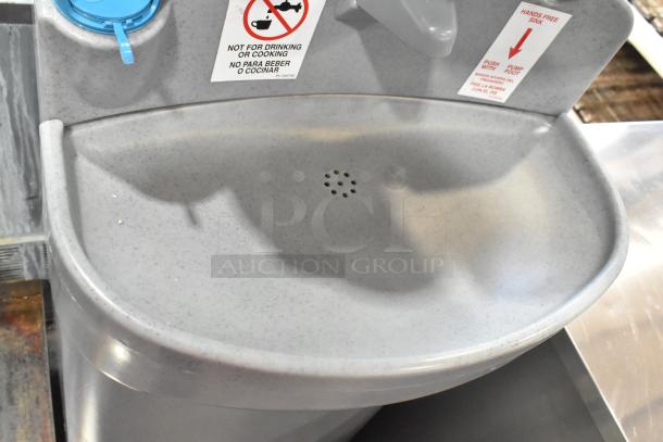 Polyjohn gray poly portable hand washing station, featuring hands-free operation, clear labeling, and durable construction.