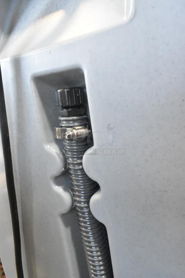 Polyjohn gray poly portable hand washing station, close-up of hose connection, sturdy construction, ideal for events.