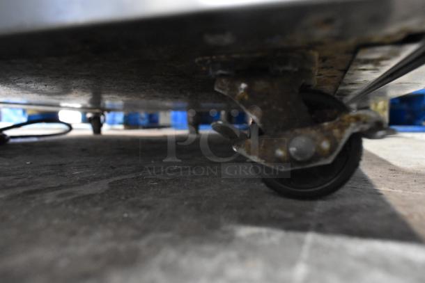 2019 Delfield 406P-STAR2 stainless steel undercounter cooler on commercial casters, showing a single caster wheel.