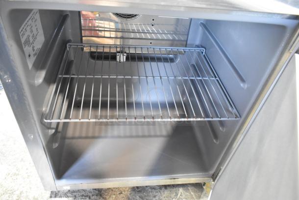 2019 Delfield 406P-STAR2 stainless steel undercounter cooler, single door, on commercial casters, interior wire shelf visible.