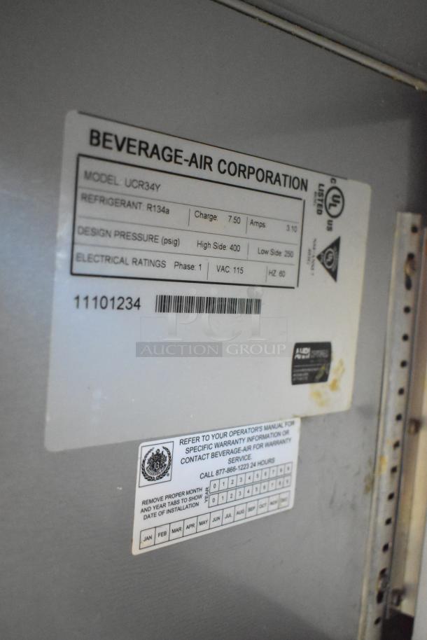 Beverage Air UCR34Y stainless steel undercounter cooler, 2 doors, commercial casters, 115V, 1 phase, model details label visible.