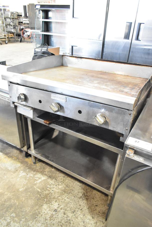 Royal stainless steel commercial countertop gas griddle on stand, good condition, featuring control knobs and grease catcher.