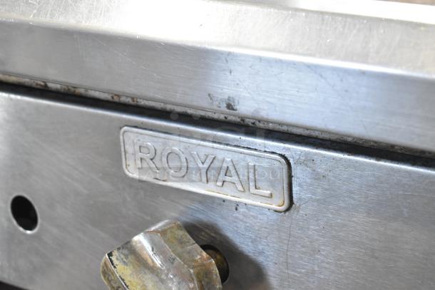 Royal stainless steel commercial gas griddle with visible brand label, mounted on equipment stand. Used condition.