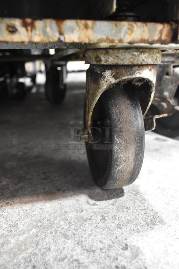 Beverage Air UCR36A cooler caster, showing rust and wear. Part of stainless steel commercial undercounter cooler.