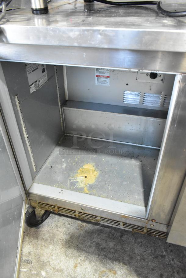 Beverage Air WTR48A stainless steel two-door undercounter cooler with commercial casters; visible interior wear and electrical specs.