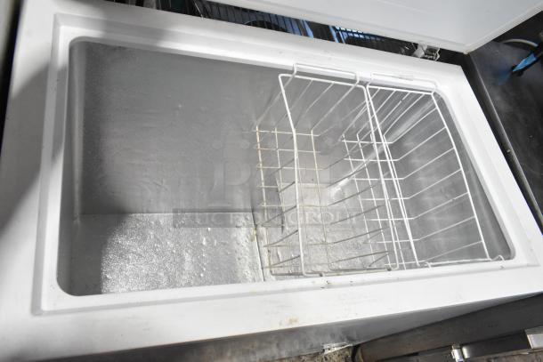 Frigidaire FFFC07M2UW metal chest freezer with hinge lid, visible storage basket, 115 volts, 1 phase; excellent condition.