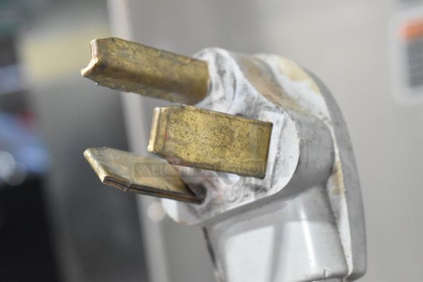 Close-up of a metal plug for the 2019 Bunn DUAL SH coffee machine, showing visible wear.