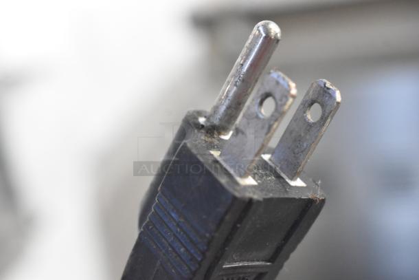 Close-up of a power plug for VacMaster VP321 vacuum sealer, showing prongs and textured grip, indicating 110 volts compatibility.