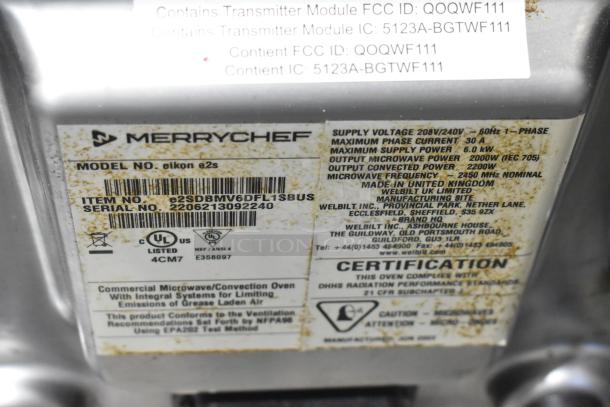Close-up of label on Merrychef eikon e2S oven detailing model, serial number, voltage, and certification information.