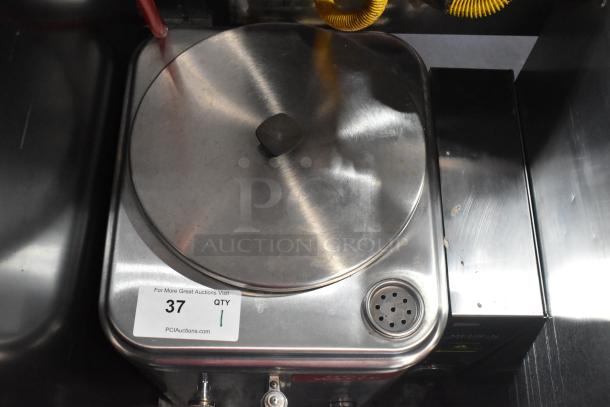 Cecilware ME10EN stainless steel coffee urn, countertop model. Features 120V, 1 phase, commercial-grade condition, auction tag visible.