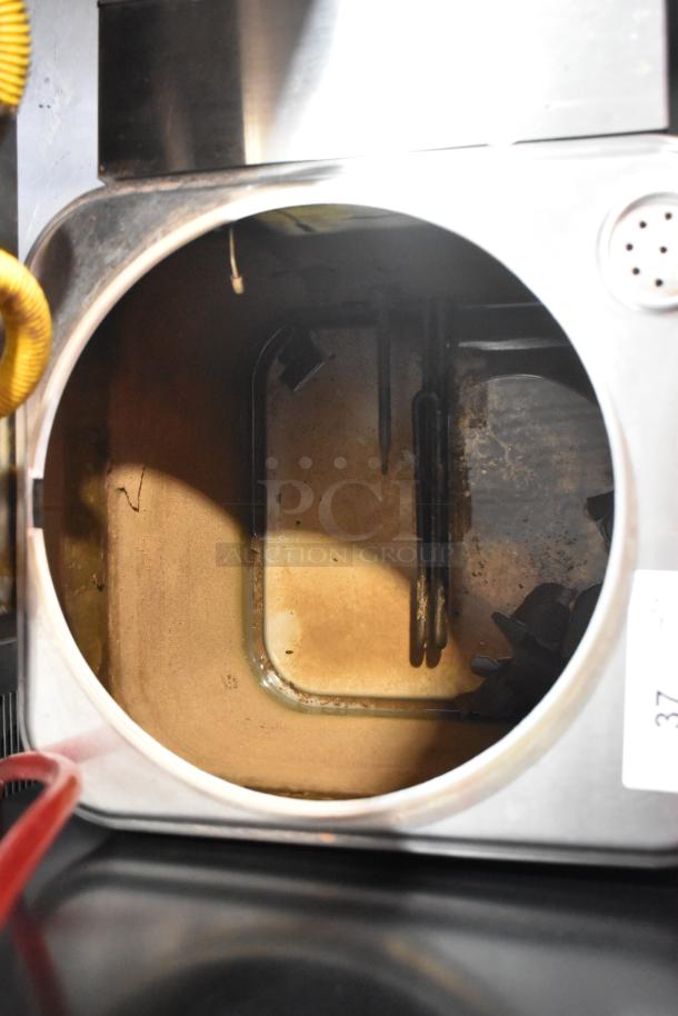 Cecilware ME10EN stainless steel commercial countertop coffee urn interior. Shows heating elements and wear. 120 volts.