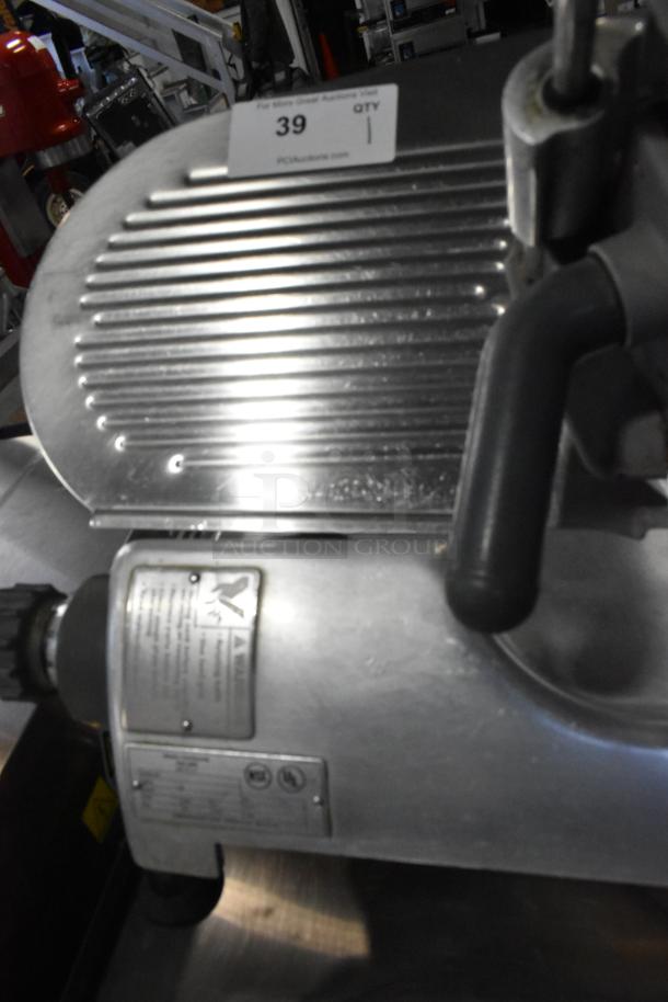 Hobart 2612 stainless steel meat slicer with blade sharpener, countertop model, 115 volts, 1 phase. Visible controls and labels.