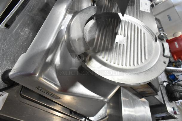 Hobart 2612 stainless steel meat slicer, includes blade sharpener. Commercial countertop model, 115 volts, 1 phase.