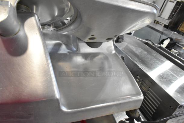 Hobart 2612 stainless steel meat slicer with blade sharpener, countertop model. 115 volts, 1 phase. Slight surface wear visible.