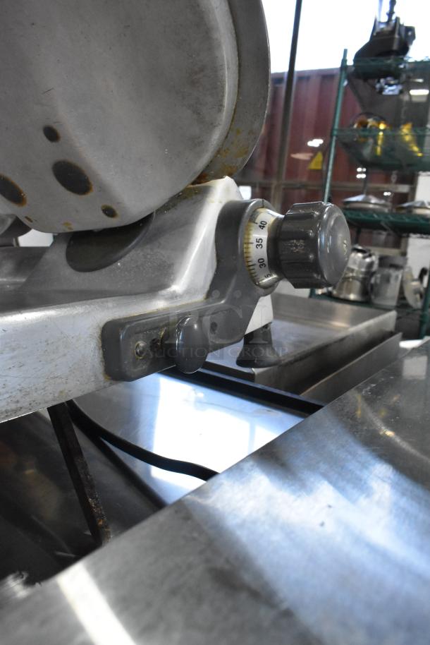 Hobart 2612 stainless steel meat slicer with blade sharpener, visible knob settings, 115 volts, 1 phase, used condition.