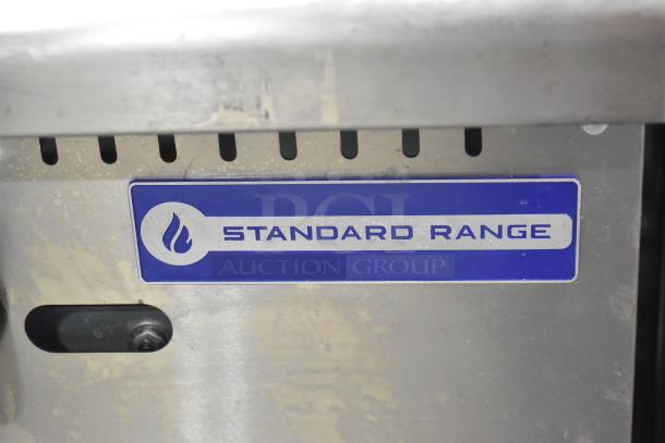 Standard Range stainless steel gas-powered griddle on commercial stand, visible logo plate, suitable for high-demand kitchens.