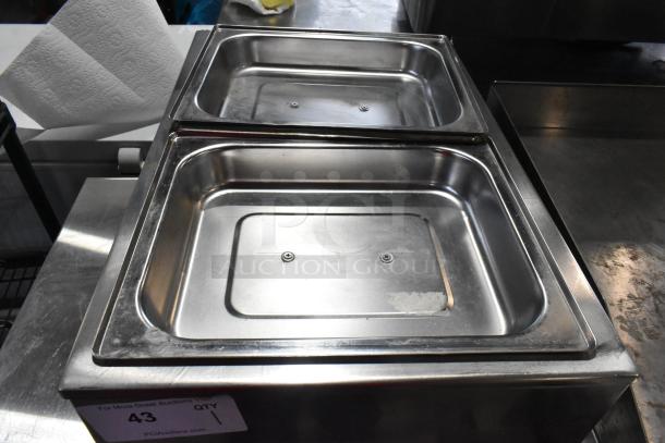 Winco FW-S500 stainless steel countertop food warmer, dual pans, 120 volts, in used condition. Auction lot 43.
