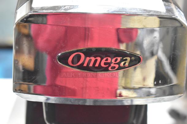 Omega M1000 Metal Countertop Single Head Drink Mixer, 120 Volts, 1 Phase, in used condition, displaying brand logo.