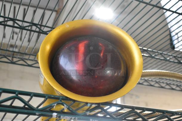 Metal 2 Head Food Warming Lamp with red heat bulb and flexible neck. Slight wear on golden housing. Ideal for catering use.