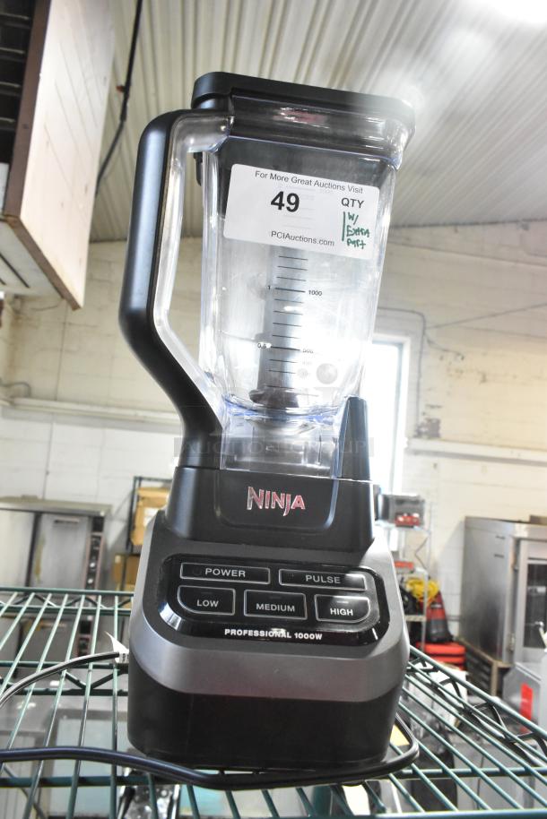 Ninja BL610 metal countertop blender, 1000W, with extra pitcher, well-maintained. Features power, pulse, low/medium/high settings.