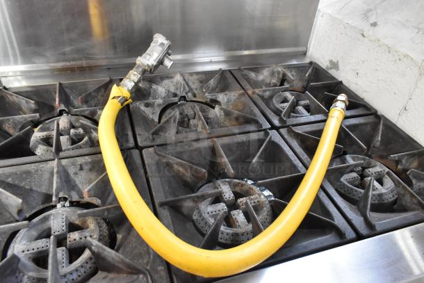 2024 Cookline CR36-6 stainless steel commercial 6-burner range with oven, over shelf, backsplash, and yellow gas hose.