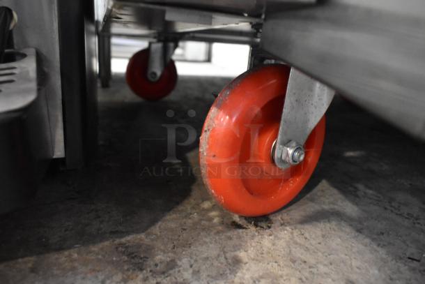 Red caster wheel for 2024 Cookline CR36-6 commercial range, highlighting mobility feature.