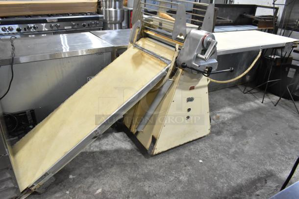 Seewer Rondo S Metal Commercial Floor Style Reversible Dough Sheeter in used condition, sturdy construction, cream and metal finish.