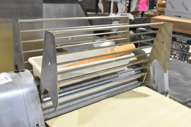 Seewer Rondo S metal reversible dough sheeter, commercial floor style, in good condition. Features a rolling pin, sturdy construction.