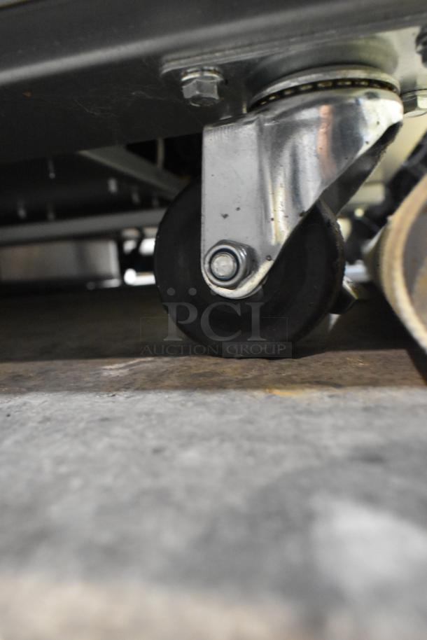 Coldline C35R cooler caster; stainless steel, commercial-grade, mounted on poly-coated wheel for durability.