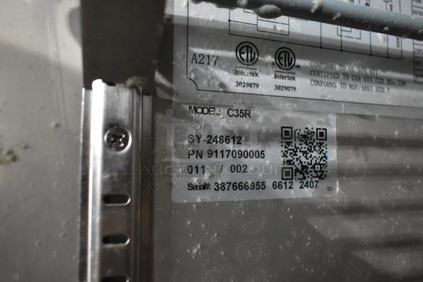 Coldline C35R label showing model, serial number, and certifications; stainless steel surface with visible frost.