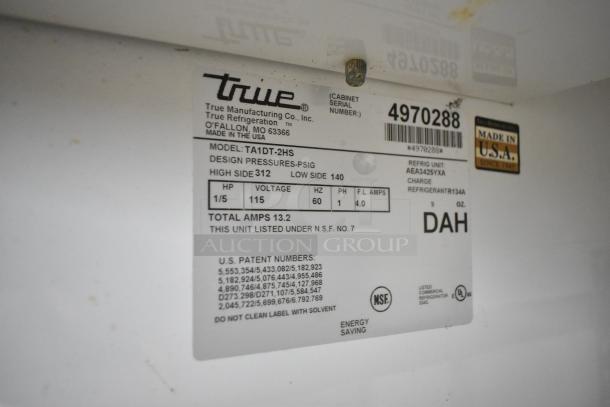 True TA1DT-2HS stainless steel reach-in cooler freezer, 2 half-size doors, commercial casters, 115 volts, NSF certified.