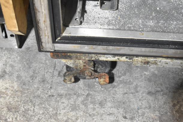 True TA1DT-2HS stainless steel cooler freezer, showing corner and worn commercial caster. 115 volts, 1 phase.